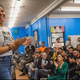 Ilona Duverge speaks in front of a crowd of people including fellows with Movement School and Rep. Alexandria Ocasio-Cortez